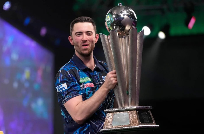 Luke Humphries lifts the World Darts Championship trophy