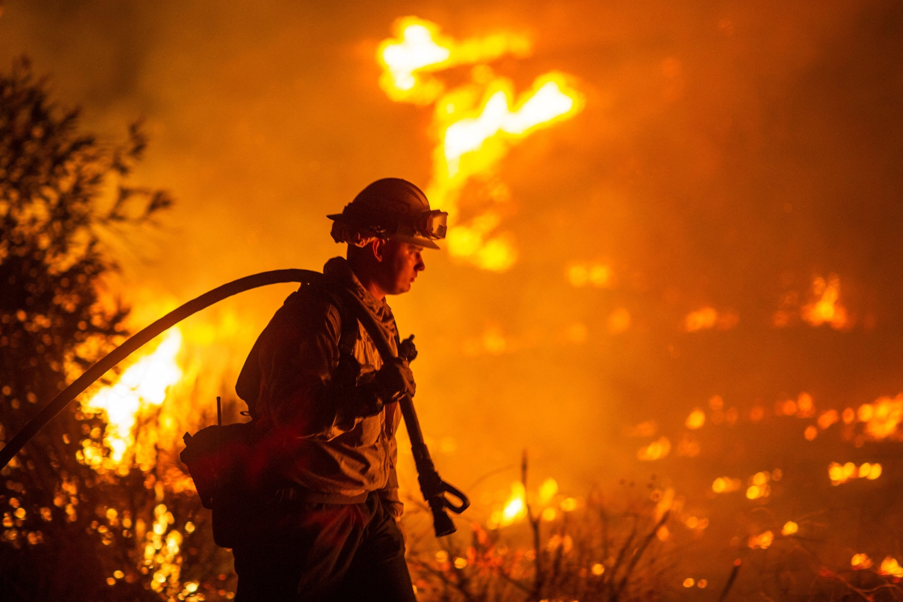 A firefighter battles the Hughes Fire near Castaic Lake.