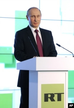 FILE - Russian President Vladimir Putin speaks as he attends an exhibition marking the 10th anniversary of RT