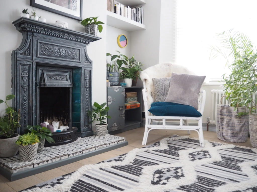 A cozy living room without a television, focusing on a comfortable reading chair and bookshelf.