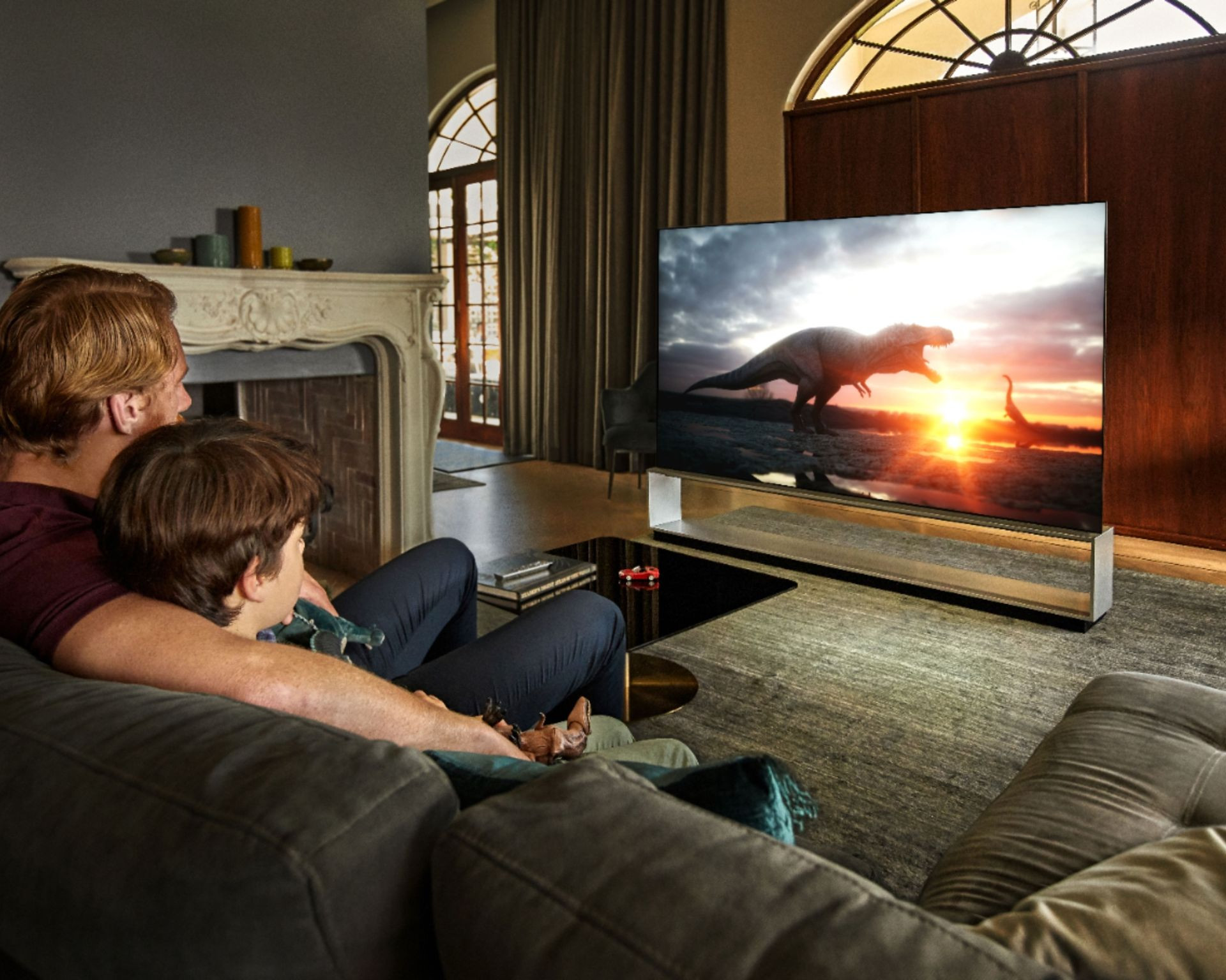 father and son watching movie on LG ZX TV