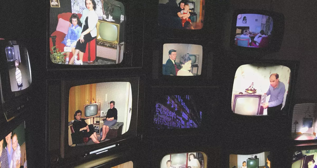 A multitude of old TV sets displaying various family-related content.