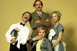 Basil Fawlty from Fawlty Towers arguing with a customer, showcasing the show's comedic brilliance