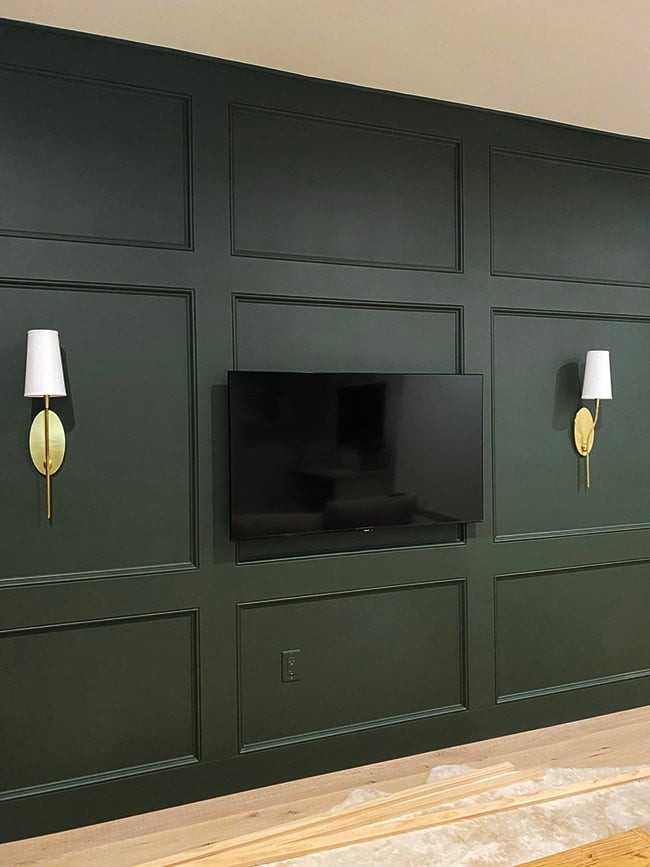 Modern living room with minimalist tv wall design featuring a wall-mounted television and a floating console